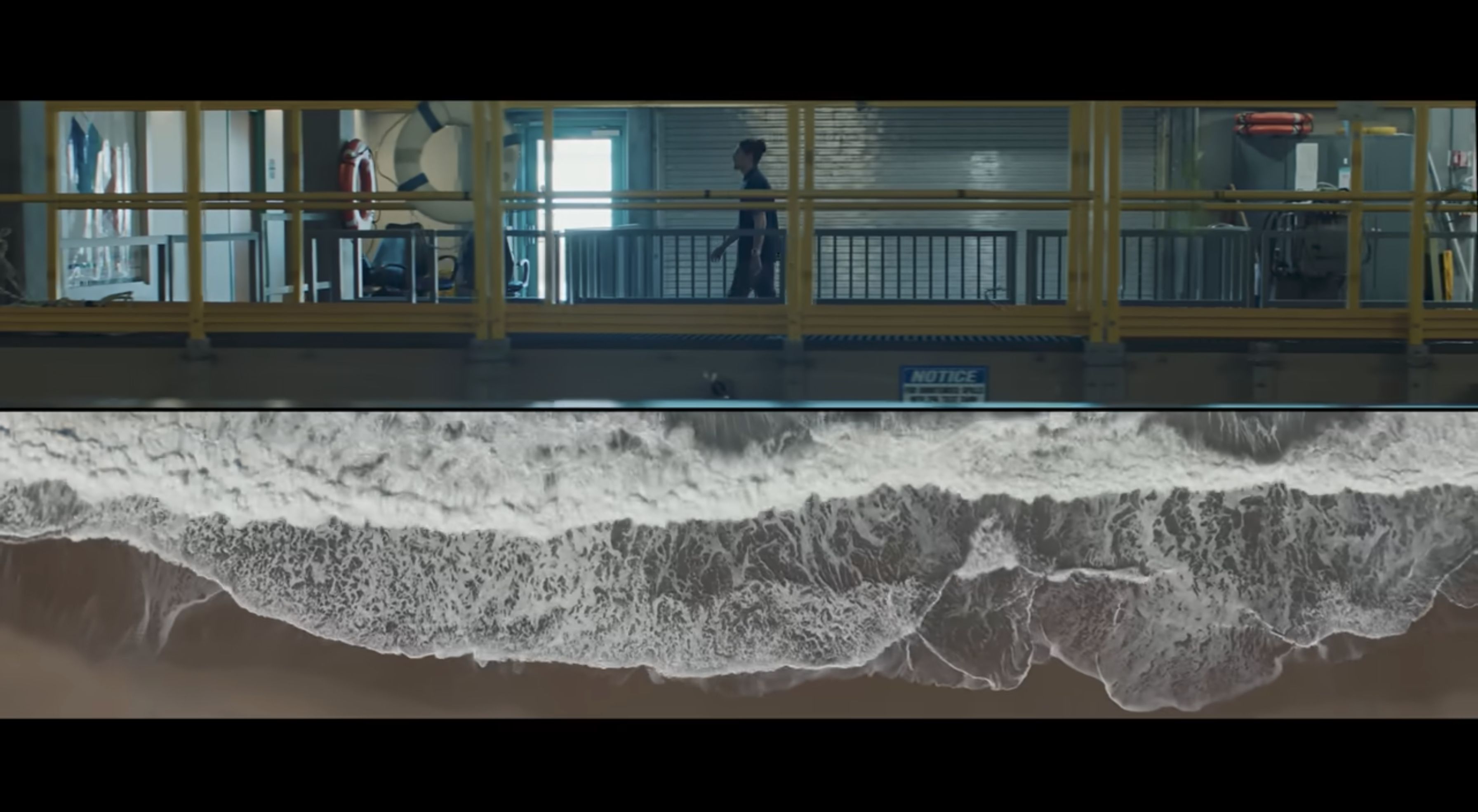 Cinematic shot of a coastline beneath a high-rise structure, with the wave below — visual benchmark for Episode 1.